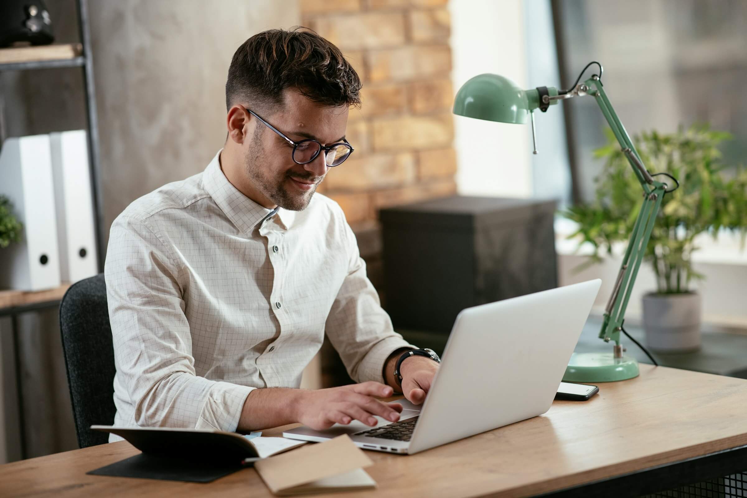 A restaurant manager working on a laptop